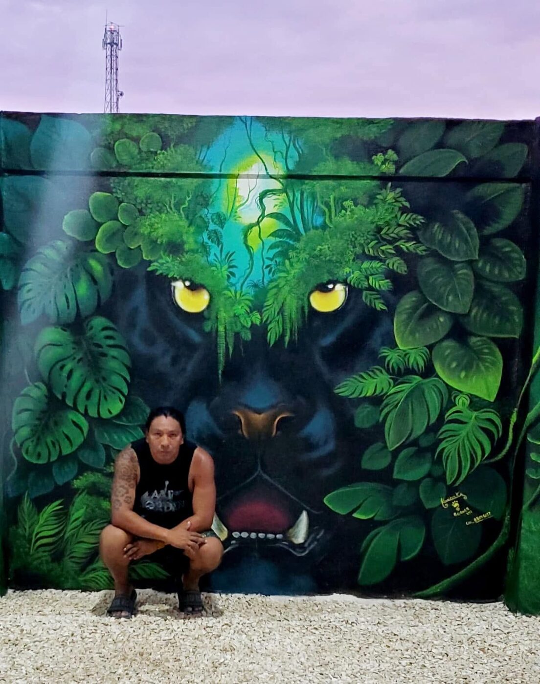 Kamel in front of his black panther mural